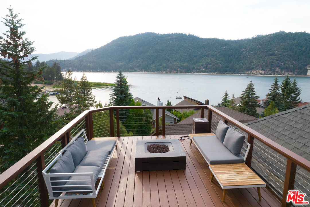 668 Cove Drive Big Bear Lake, CA 92315 - Photo 1 of 31 a view of a balcony with mountain view and wooden floor