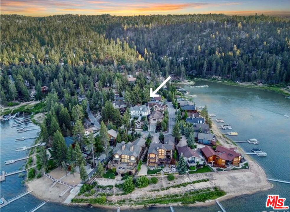 668 Cove Drive Big Bear Lake, CA 92315 - Photo 2 of 31 a view of a lake with a mountain and trees all around