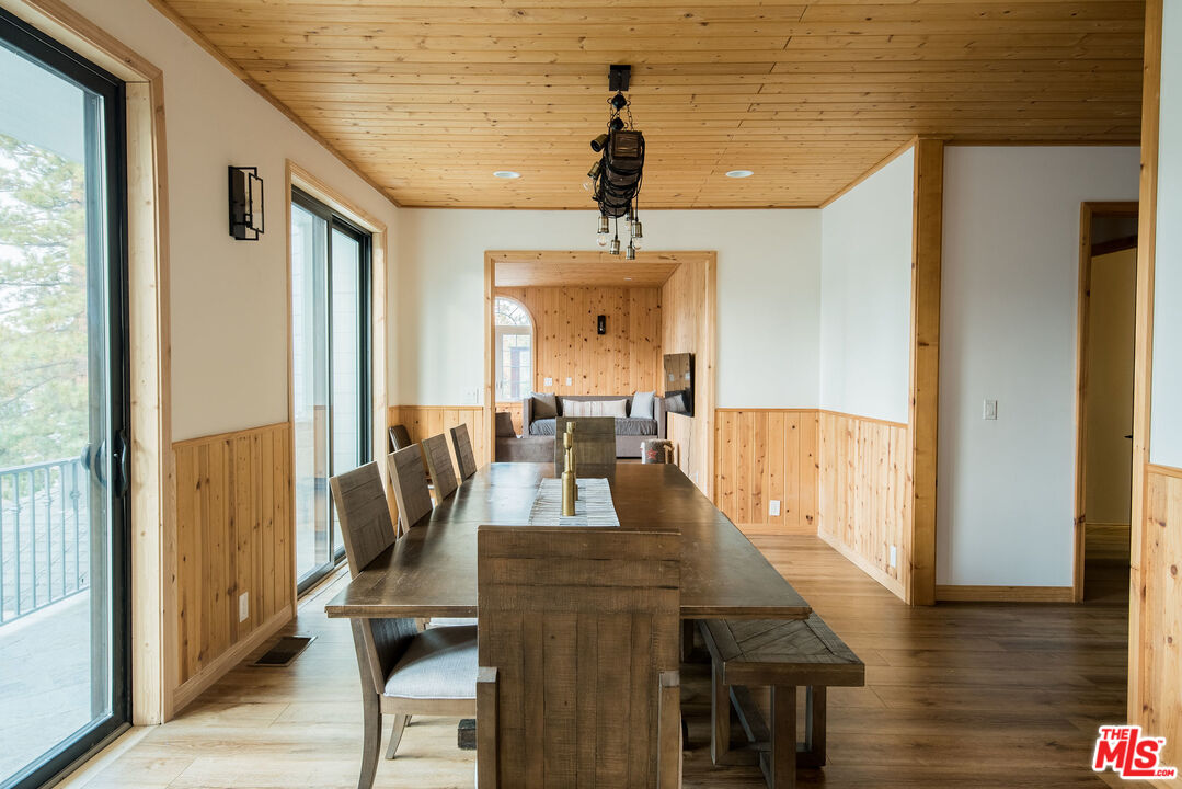 668 Cove Drive Big Bear Lake, CA 92315 - Photo 11 of 31 a view of a dining room with furniture window and wooden floor