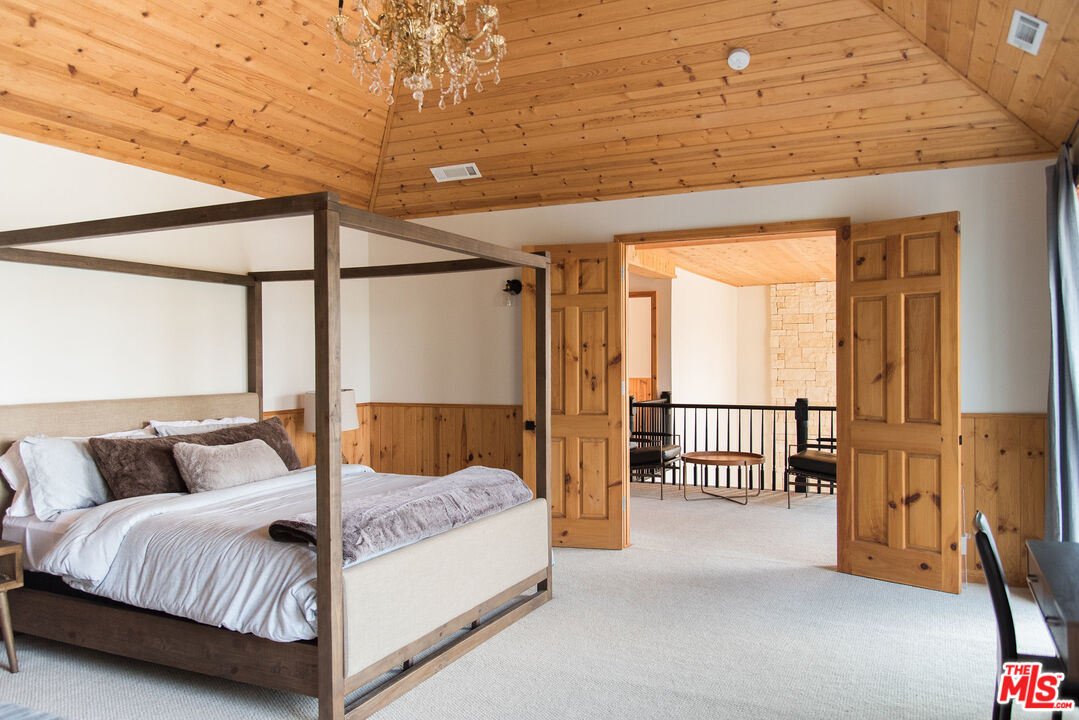 668 Cove Drive Big Bear Lake, CA 92315 - Photo 13 of 31 a bedroom with a bed and a window