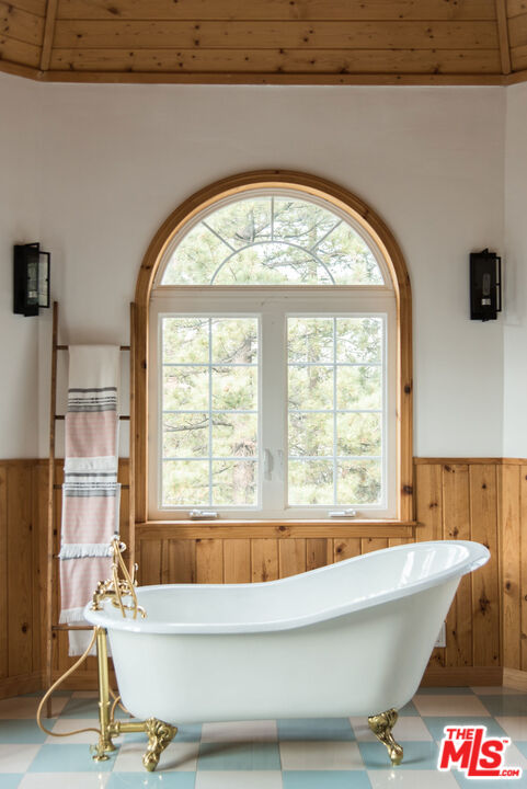 668 Cove Drive Big Bear Lake, CA 92315 - Photo 17 of 31 a bath tub sitting in a bathroom next to a window