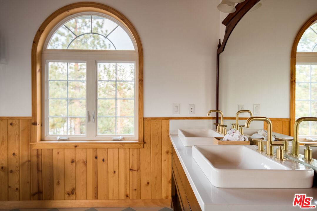 668 Cove Drive Big Bear Lake, CA 92315 - Photo 18 of 31 a bathroom with a sink mirror and a window