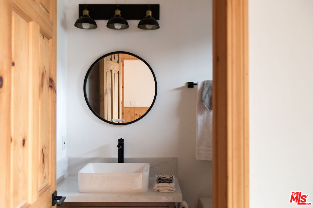 668 Cove Drive Big Bear Lake, CA 92315 - Photo 25 of 31 a bathroom with a sink and a mirror