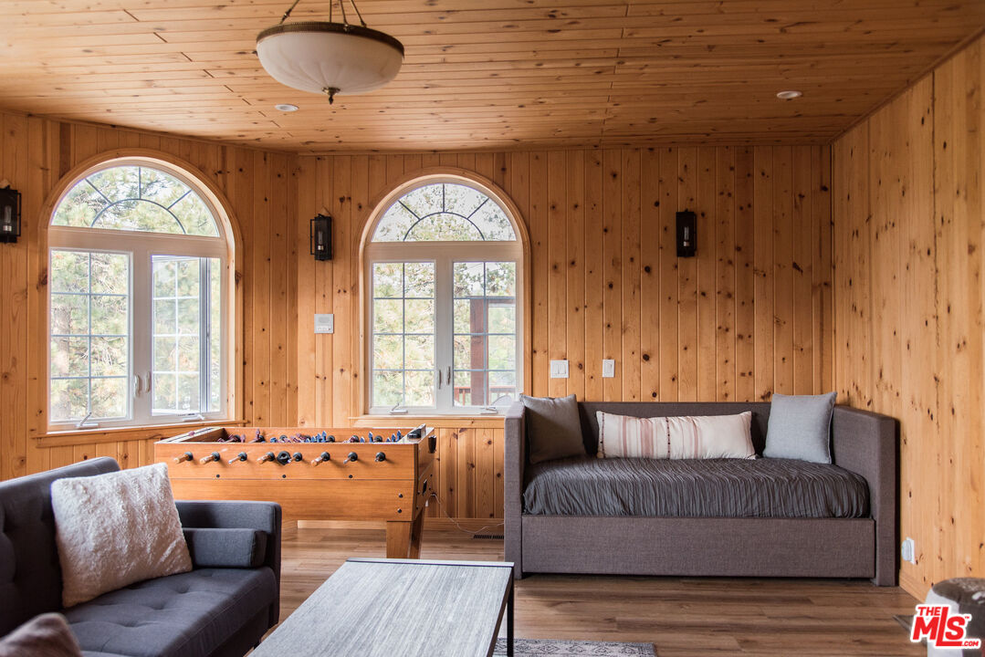 668 Cove Drive Big Bear Lake, CA 92315 - Photo 27 of 31 a living room with furniture and a large window