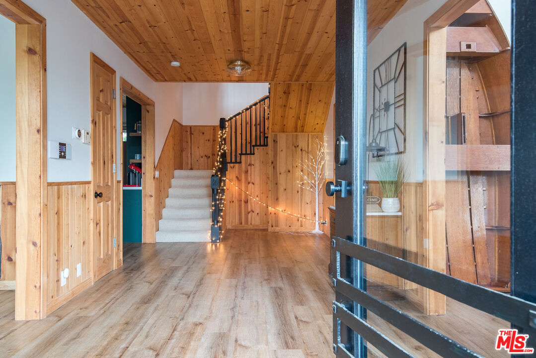 668 Cove Drive Big Bear Lake, CA 92315 - Photo 29 of 31 a view of a hallway with wooden floor and staircase