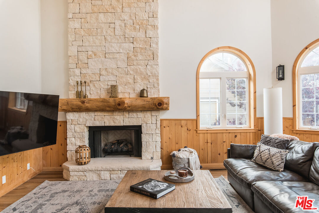 668 Cove Drive Big Bear Lake, CA 92315 - Photo 4 of 31 a living room with furniture a flat screen tv and a fireplace