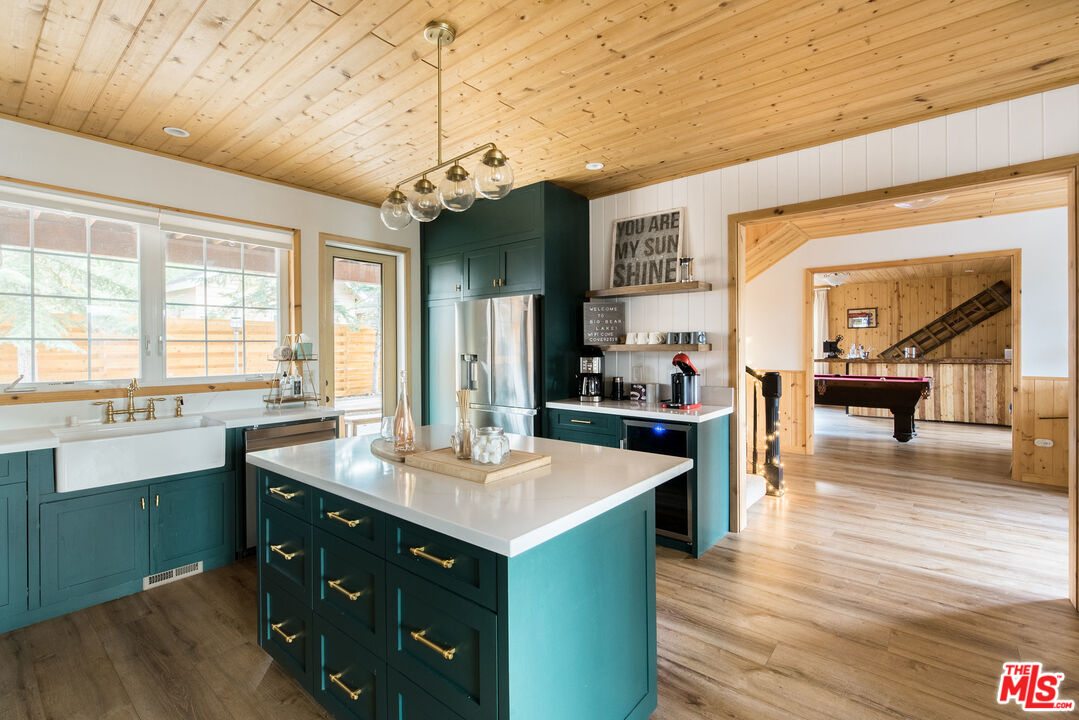 668 Cove Drive Big Bear Lake, CA 92315 - Photo 6 of 31 a kitchen with sink cabinets and wooden floor