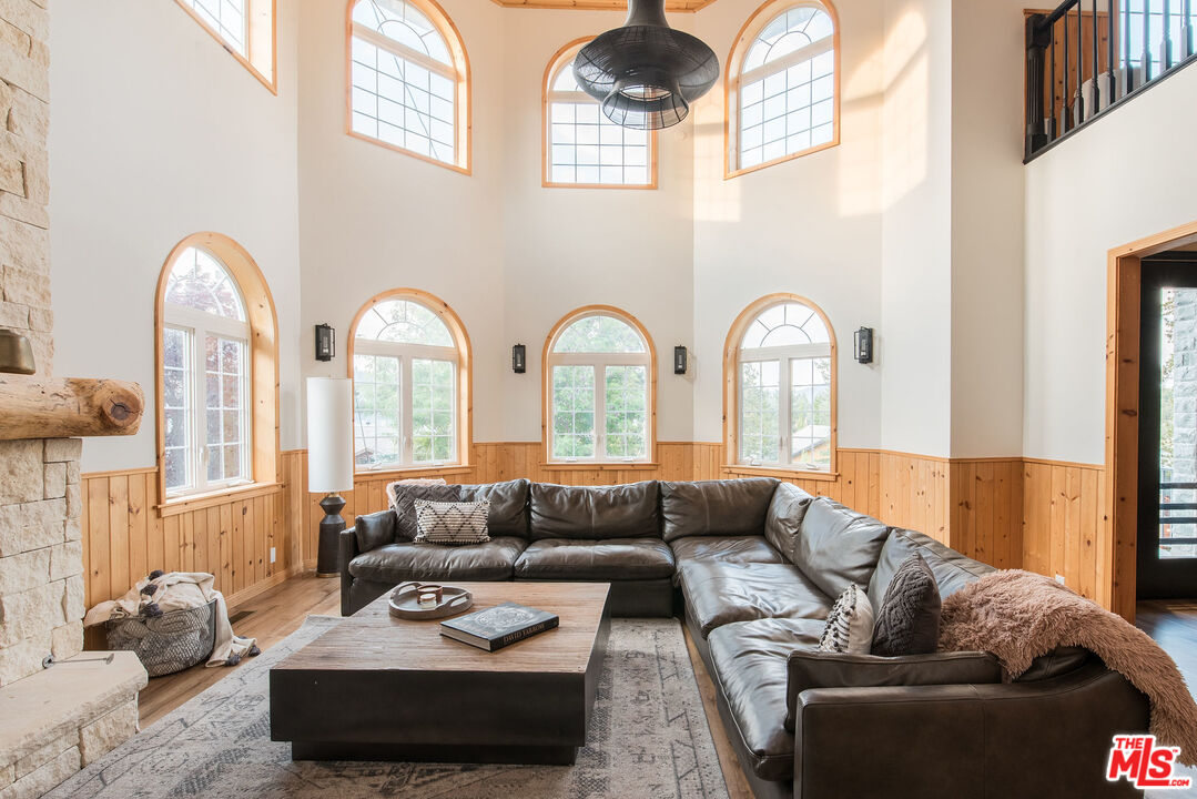 668 Cove Drive Big Bear Lake, CA 92315 - Photo 9 of 31 a living room with furniture fireplace and a large window