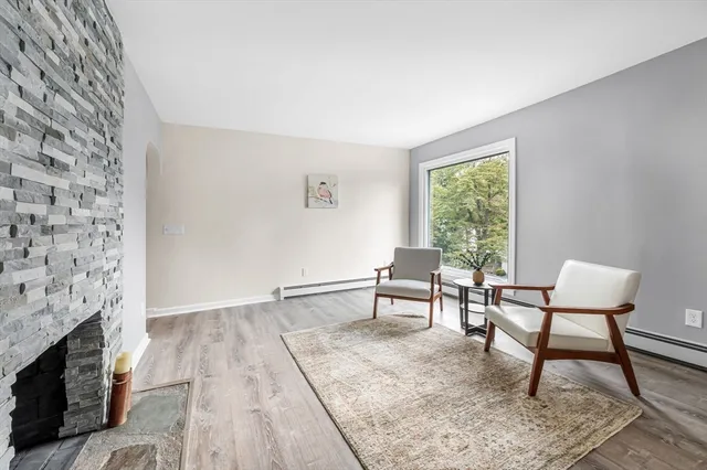 a view of a livingroom with furniture and a fireplace