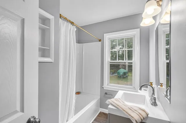 a bathroom with a tub and a sink