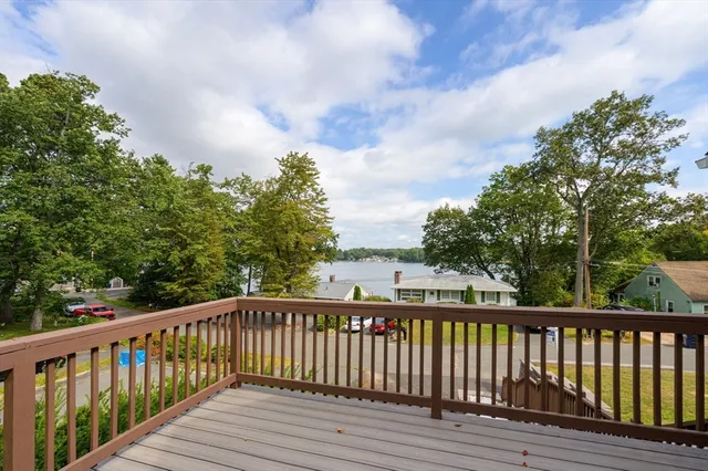 a view of balcony with wooden floor and fence