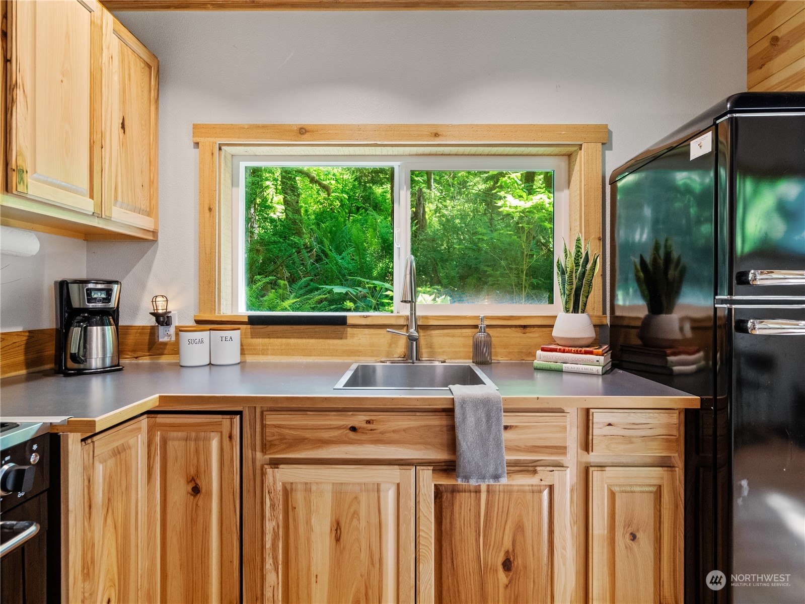 51818 South Riverside Road Gold Bar, WA 98251 - Photo 12 of 35 a kitchen with stainless steel appliances a sink stove and a large window