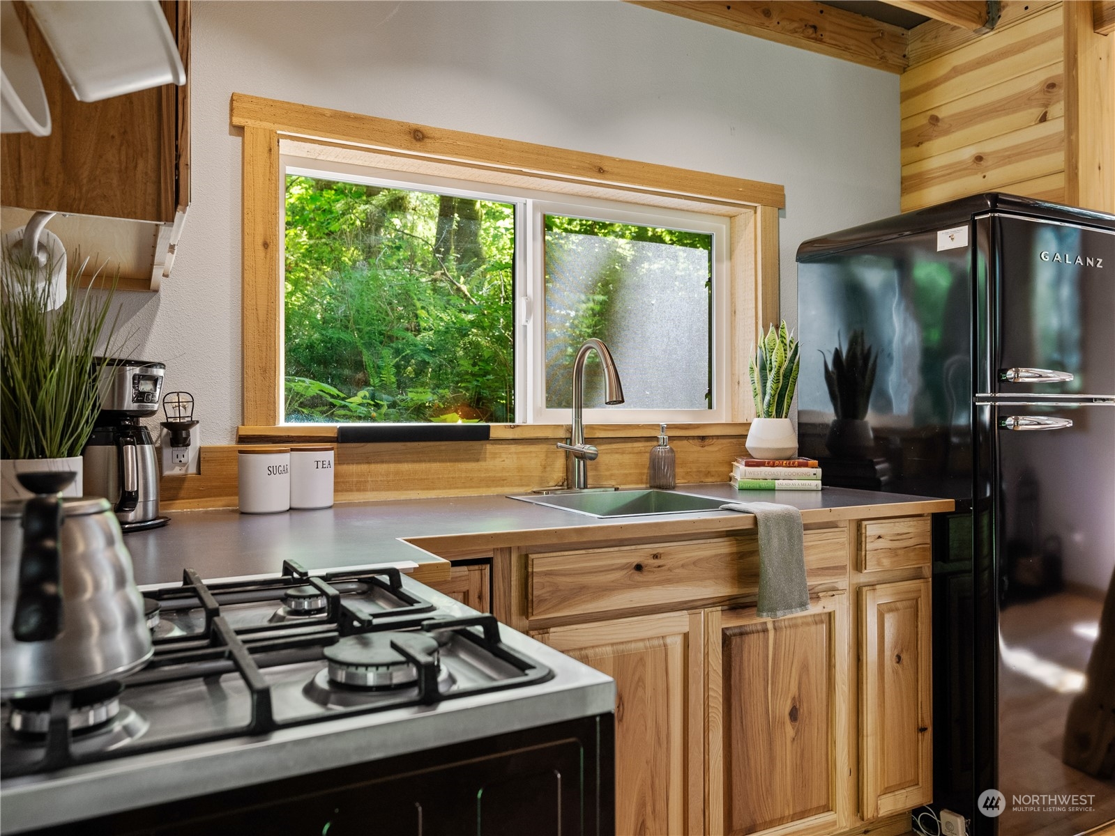 51818 South Riverside Road Gold Bar, WA 98251 - Photo 10 of 35 a kitchen with a stove a sink and a large window