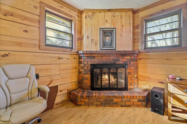a view of a dining room with furniture a chandelier and wooden floor