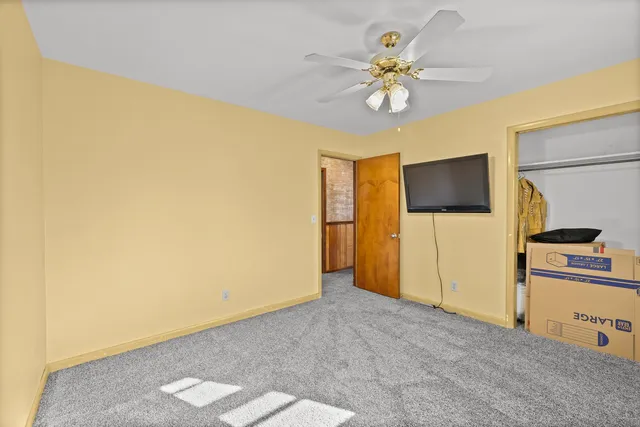 a bedroom with a bed and a dresser