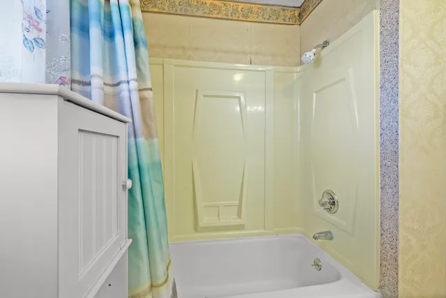 a view of a porch with wooden floor and fence