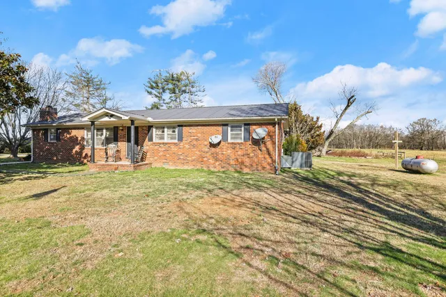 a living room with furniture a rug and a window