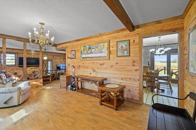 a living room with furniture a fireplace and a large window