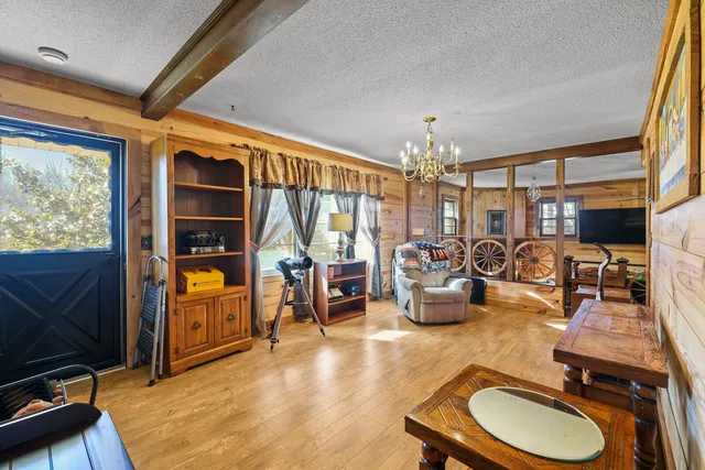 a living room with furniture a rug and a chandelier