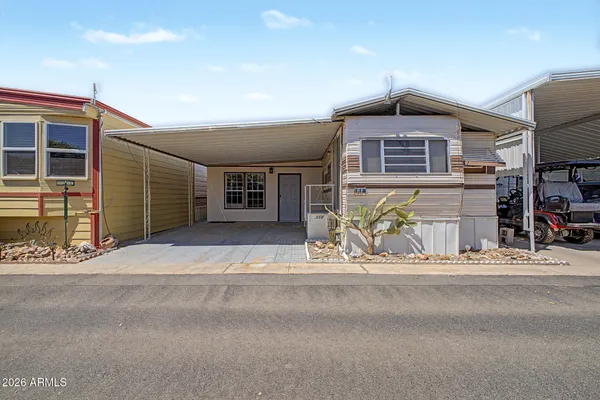 a front view of a house with a garden and parking space