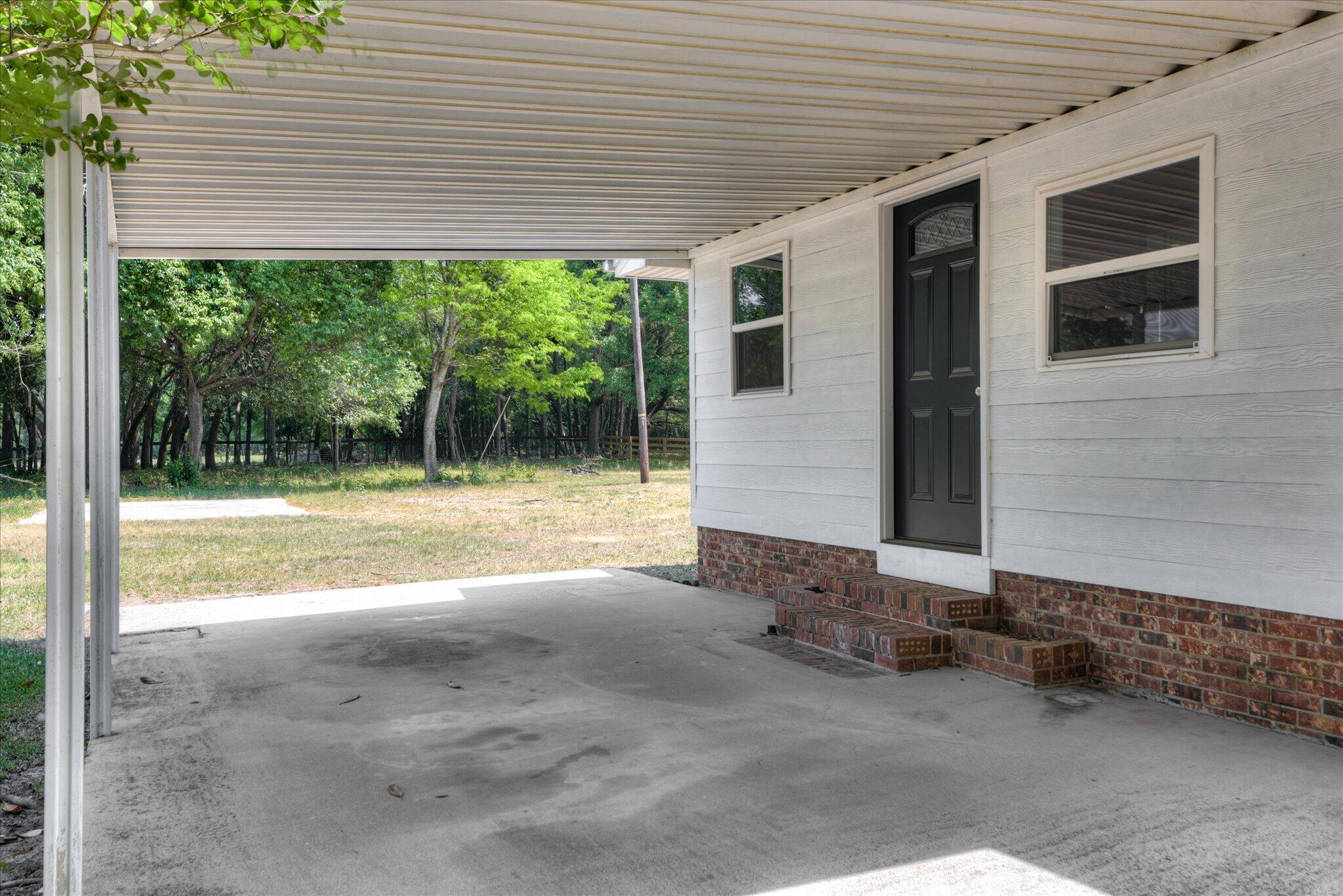 126 Mosley Road Aiken, SC 29801 - Photo 26 of 29 a view of a porch with furniture and garden