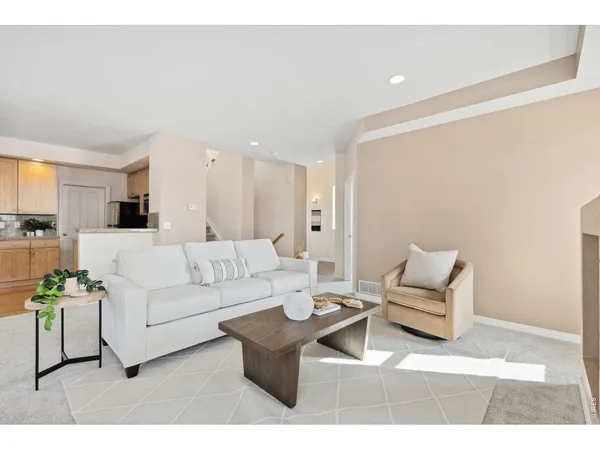 a living room with furniture a rug and white walls