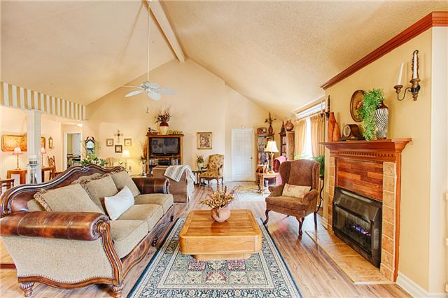 30728 Quail Trail Road Ardmore, TN 38449 - Photo 17 of 20 Great room is so open and spacious with gas log fireplace, recessed lighting, vaulted ceiling, and laminate flooring!
