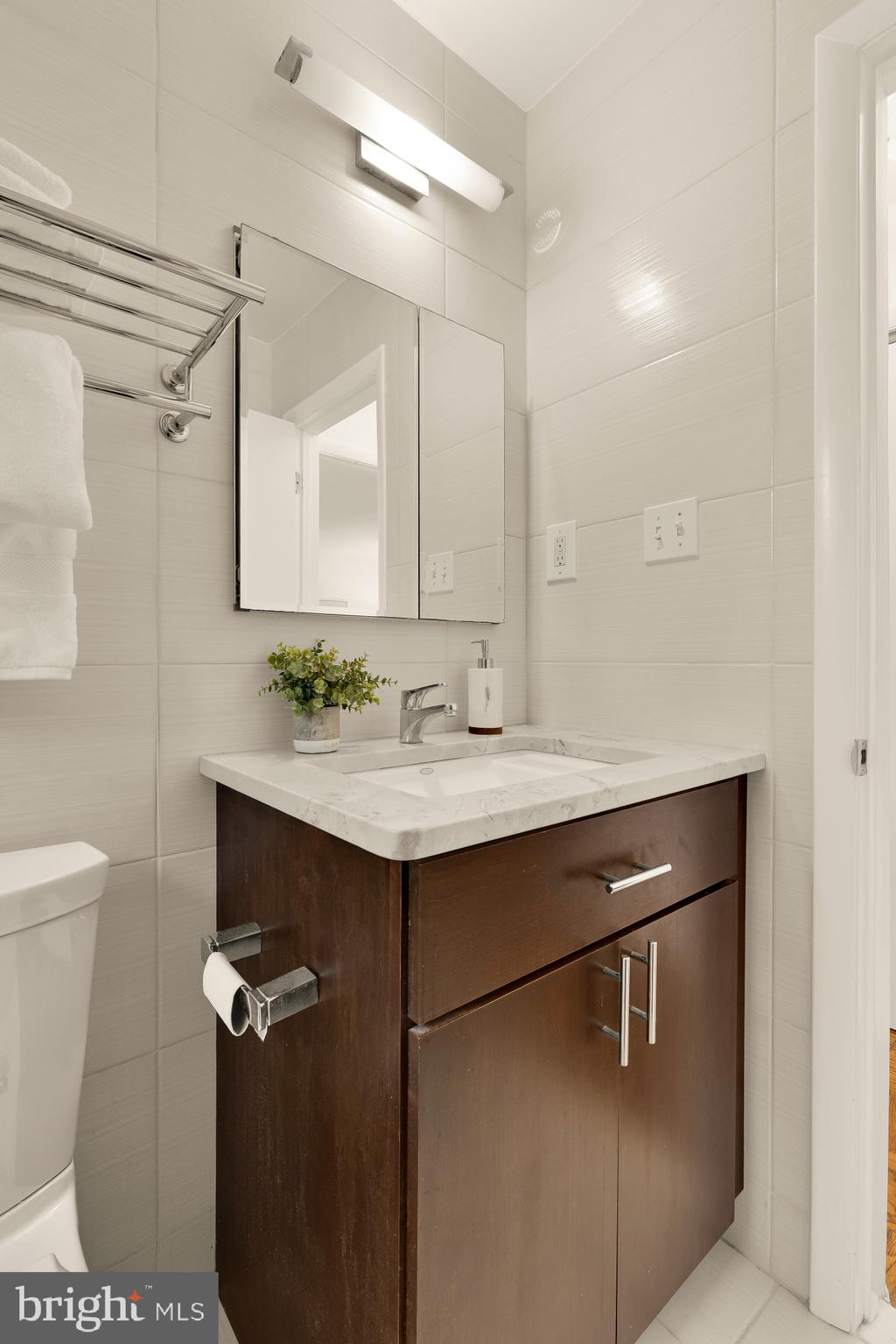 2400 41st Street Northwest, Unit 212 Washington, DC 20007 - Photo 21 of 24 a bathroom with a sink vanity and a mirror