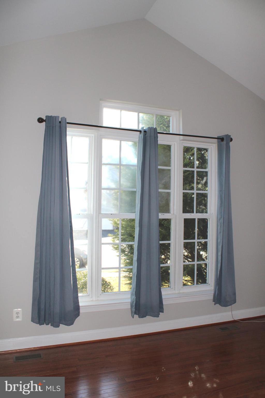42770 Conquest Circle Brambleton, VA 20148 - Photo 19 of 70 a view of an empty room with wooden floor and a window