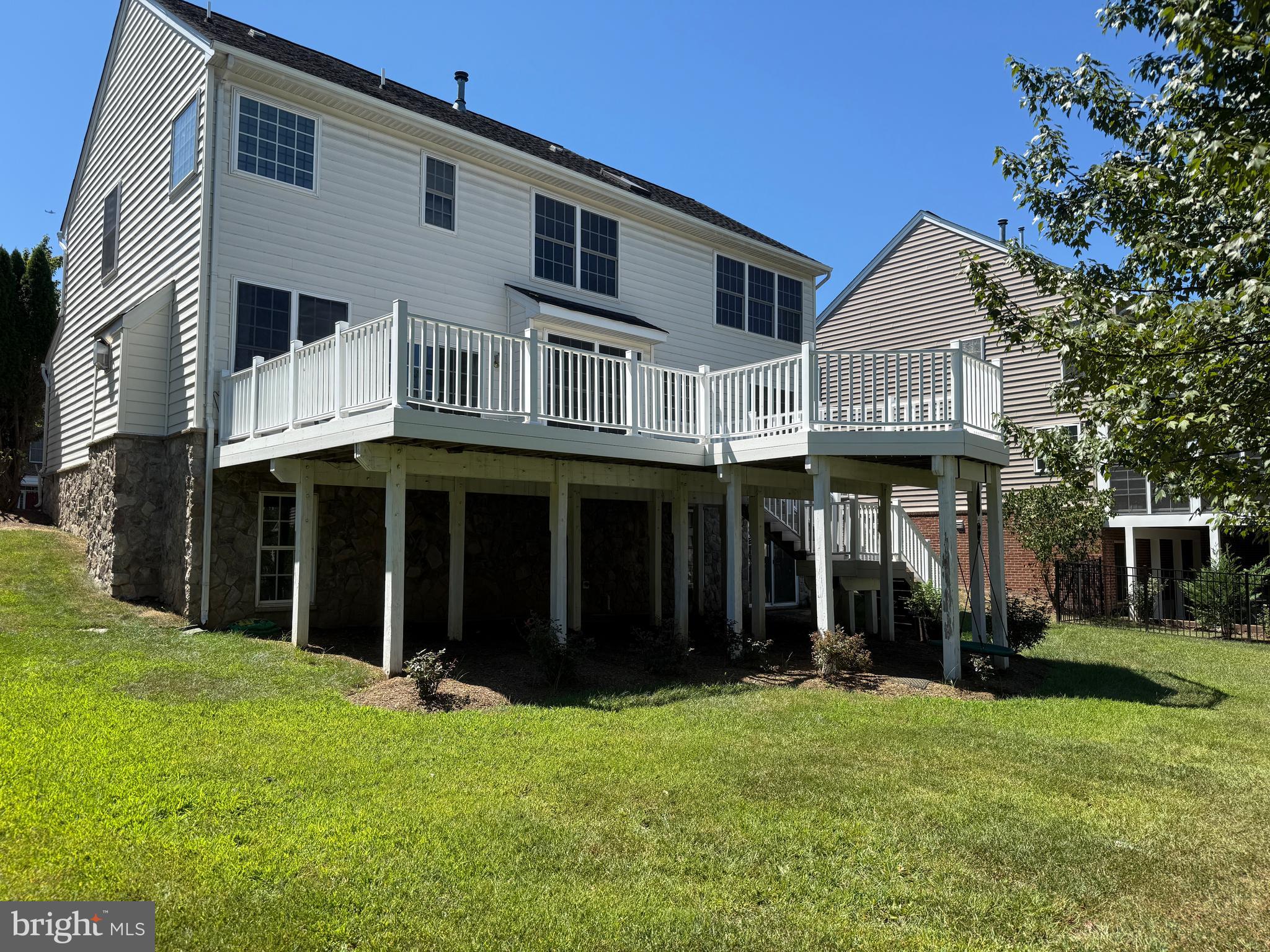 42770 Conquest Circle Brambleton, VA 20148 - Photo 67 of 70 a view of a white house with large windows and a yard