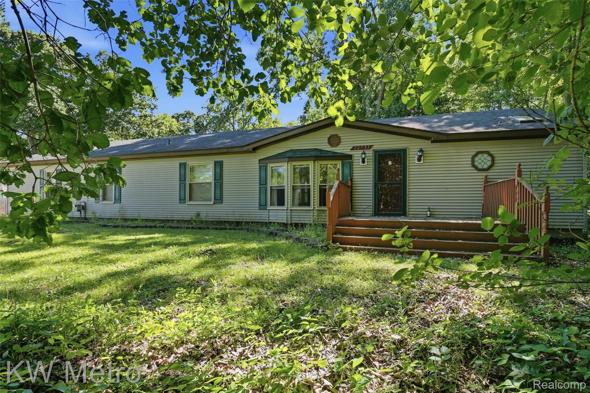 22733 Sumpter Road Belleville, MI 48111 - Photo 2 of 52 Single-story residence featuring light-colored horizontal siding and a dark roof