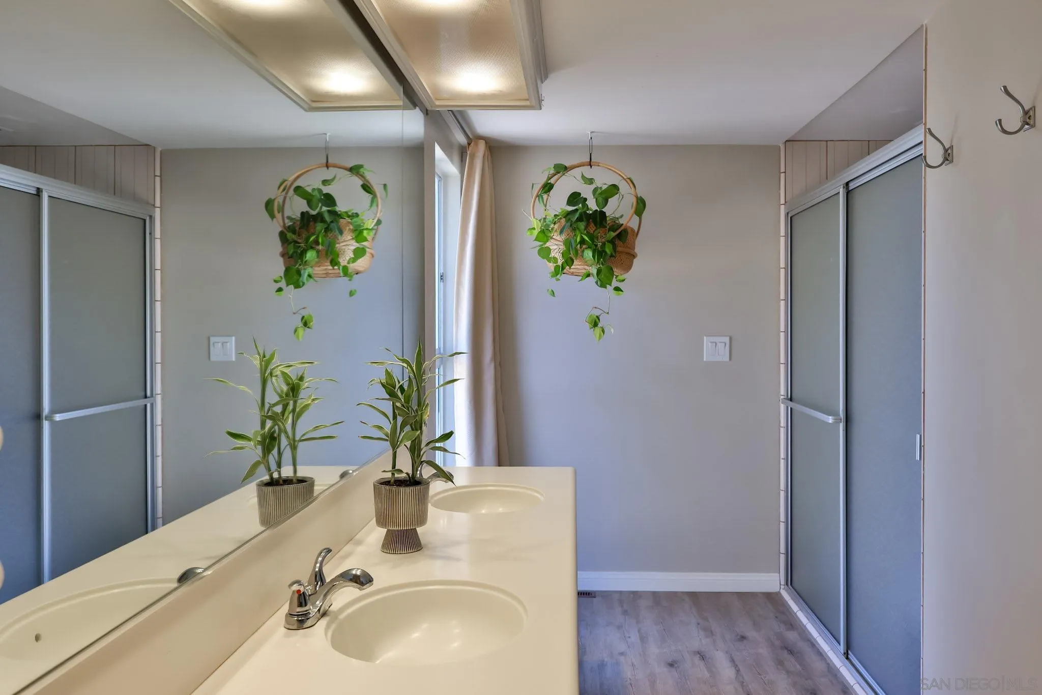 10993 Explorer Road La Mesa, CA 91941 - Photo 12 of 34 a bathroom with a sink and a mirror