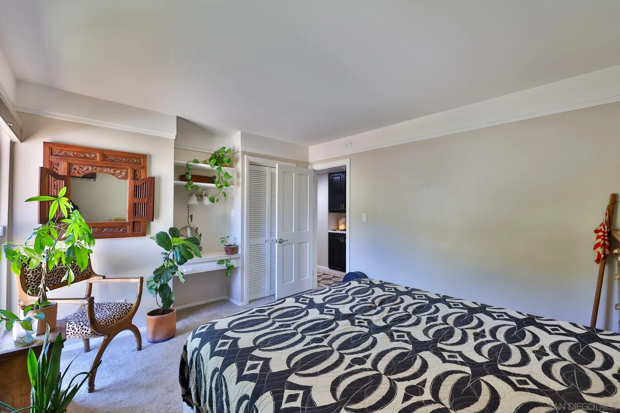 10993 Explorer Road La Mesa, CA 91941 - Photo 13 of 34 a bedroom with a bed and a potted plant