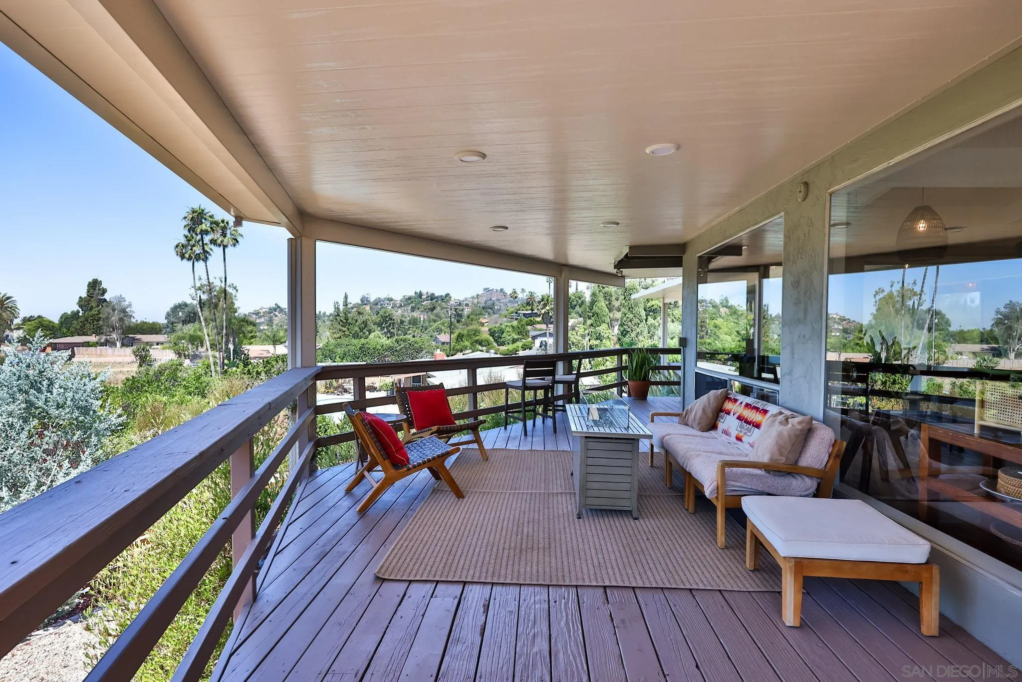 10993 Explorer Road La Mesa, CA 91941 - Photo 16 of 34 a living room with large windows and wooden floor