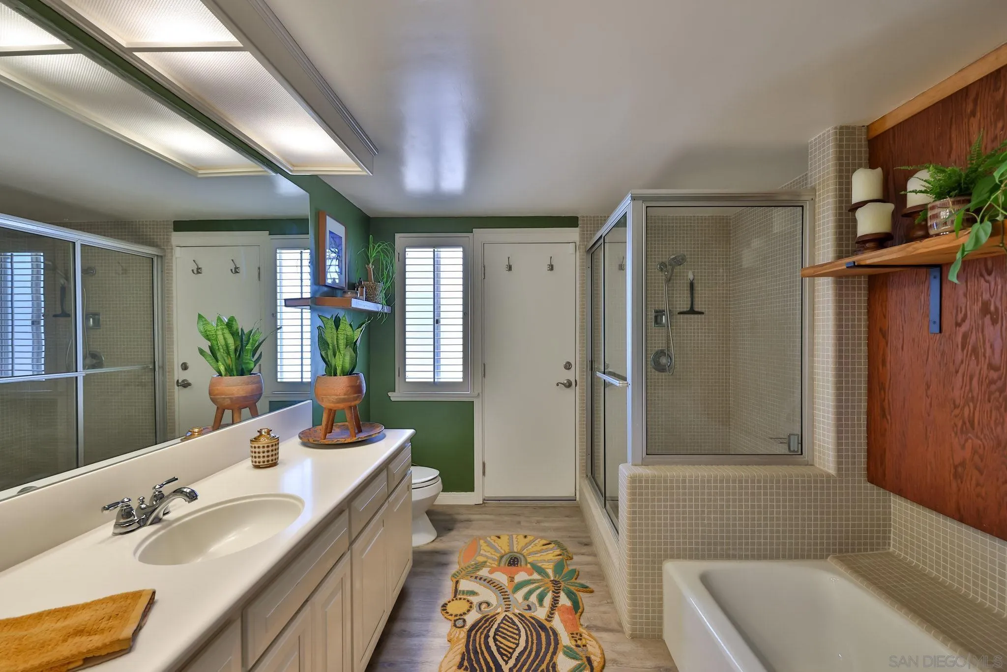 10993 Explorer Road La Mesa, CA 91941 - Photo 9 of 34 a spacious bathroom with a tub sink and mirror