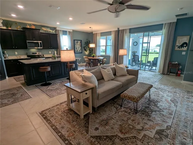 a living room with furniture and a chandelier