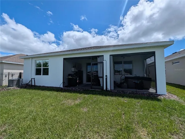 a view of a house with a yard and a garden