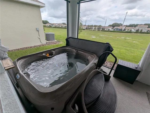 a view of a livingroom with furniture and a floor to ceiling window