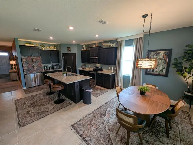 a dining room with furniture and wooden floor