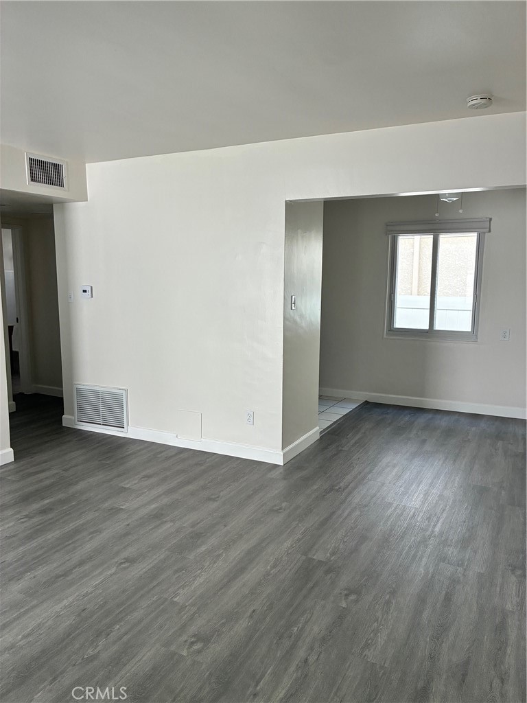 640 West Imperial Avenue, Unit 2 El Segundo, CA 90245 - Photo 3 of 9 an empty room with wooden floor and windows