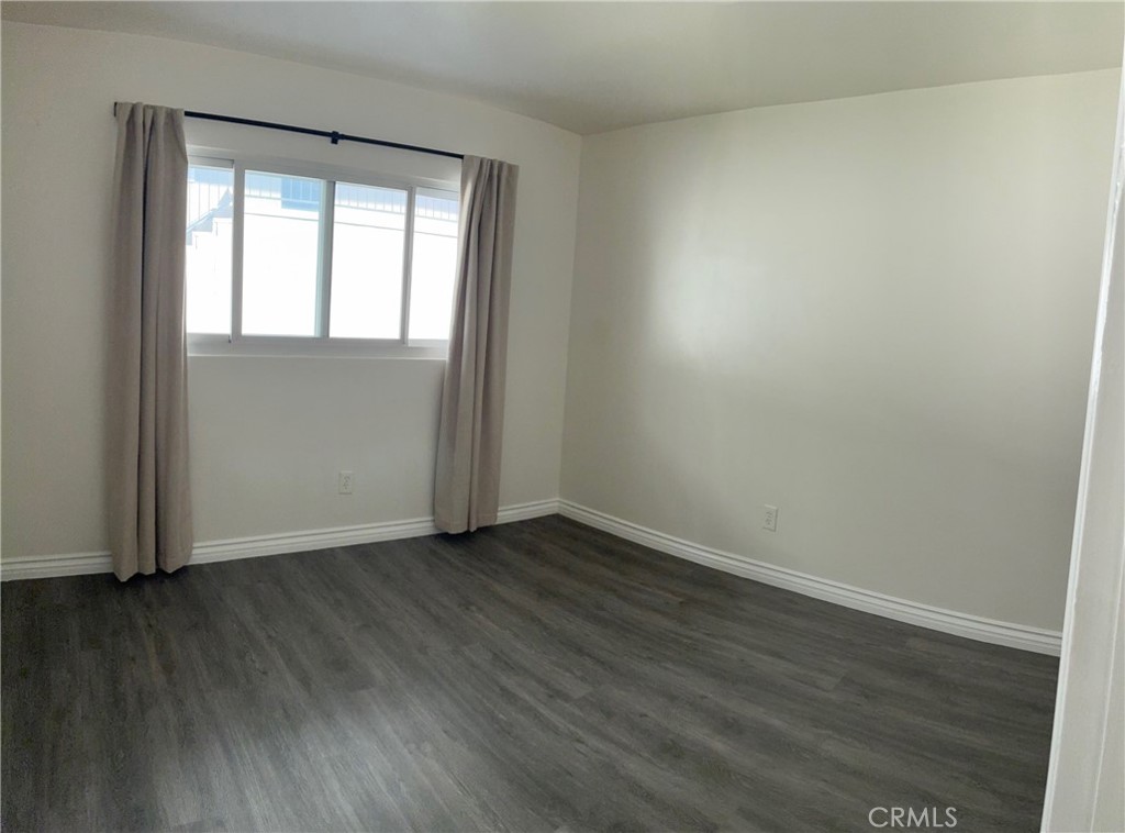 640 West Imperial Avenue, Unit 2 El Segundo, CA 90245 - Photo 8 of 9 an empty room with wooden floor and windows