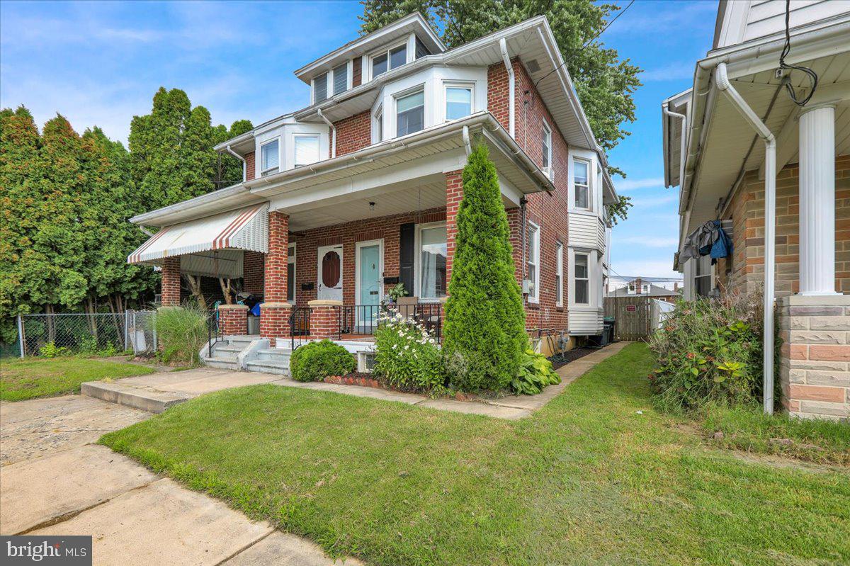 1405 Fern Avenue Reading, PA 19607 - Photo 3 of 24 a front view of a house with garden and porch