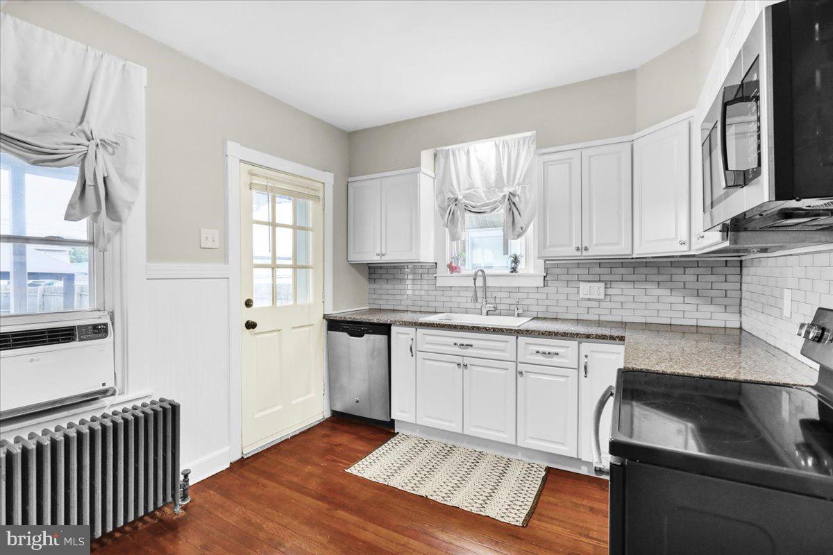 1405 Fern Avenue Reading, PA 19607 - Photo 9 of 24 a kitchen with granite countertop white cabinets stainless steel appliances a sink and a window
