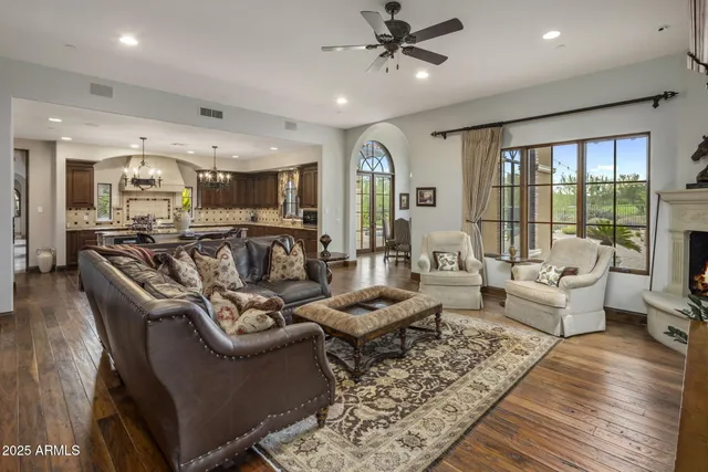 a spacious bedroom with a bed a couch and a fireplace