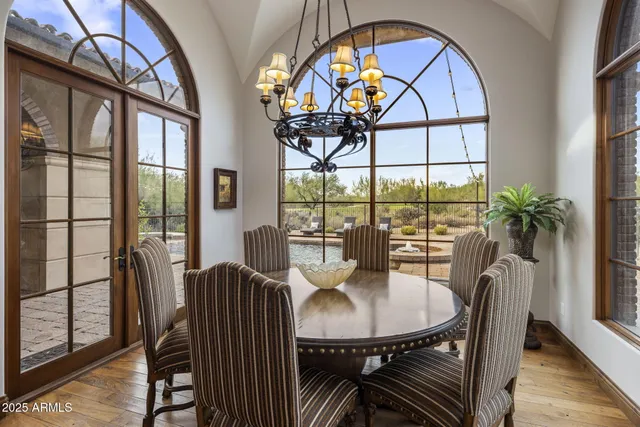 a spacious bedroom with a bed a couch and a chandelier
