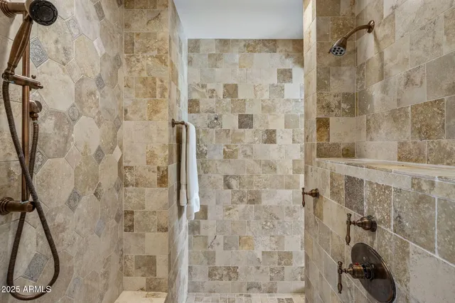 a bathroom with a granite countertop double vanity sink and mirror