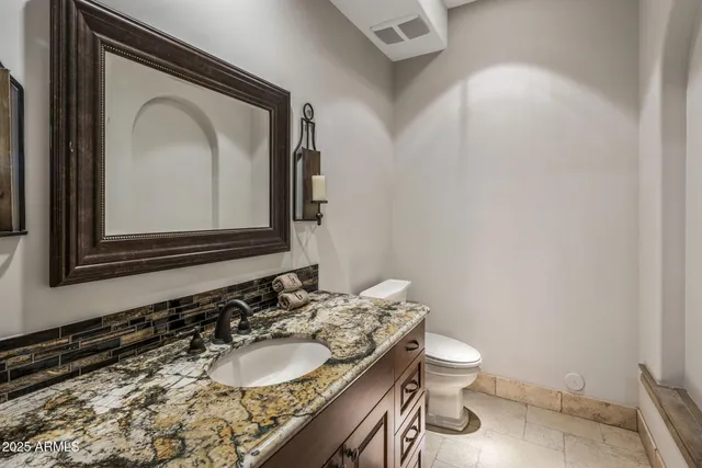 a kitchen with a sink cabinets and wooden floor