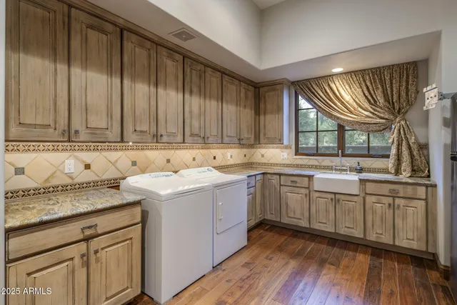 a bathroom with a granite countertop sink a mirror and shower