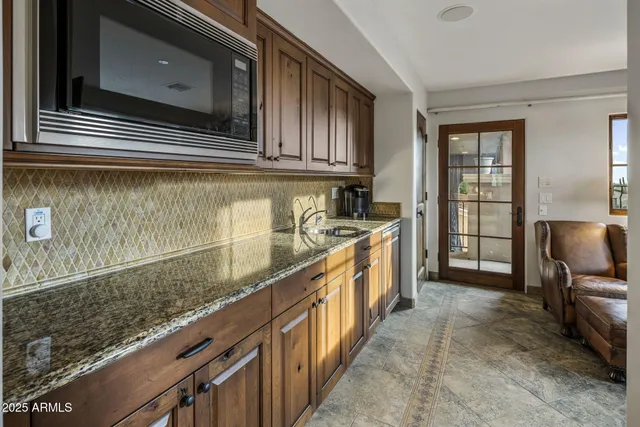 a view of a patio with a table and chairs