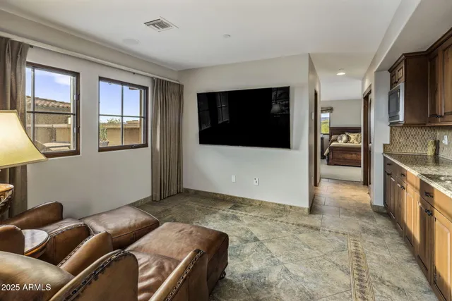 a view of a dining room with furniture a chandelier and a rug